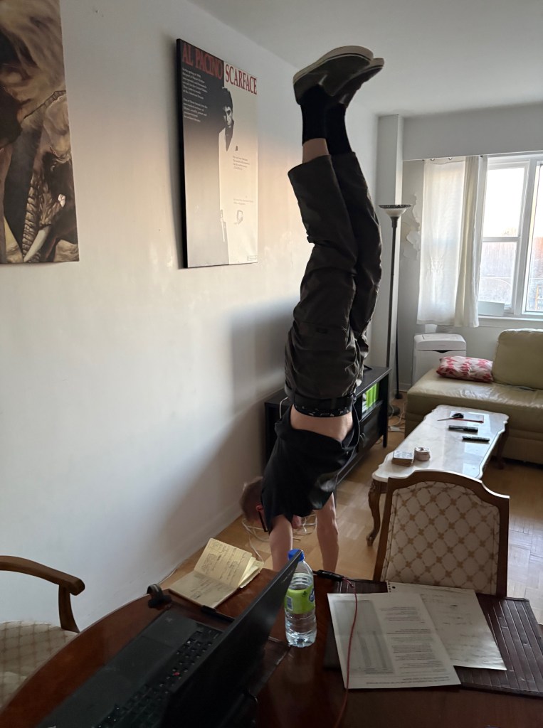Rad Dyner performing a handstand balance in his living room.